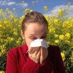 woman with allergies in field